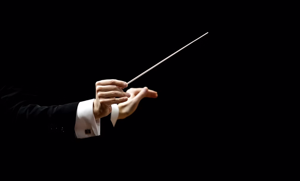 Conductor guiding an orchestra